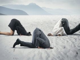 Fear of crisis with businessman like an ostrich